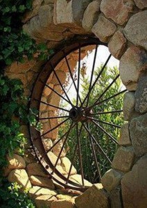 WAGON-WHEEL-CAN-BE-INSERTED-INTO-A-ROCK-WALL-FOR-A-RUSTIC-FRENCH-VIBE